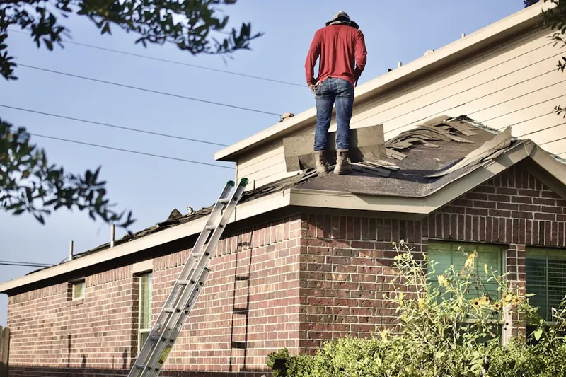 Professional roofer working on a residential roof in Galesville